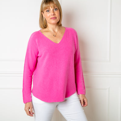 The fuchsia pink Soft V Neck Jumper with long sleeves and statement seam detailing from the shoulder down